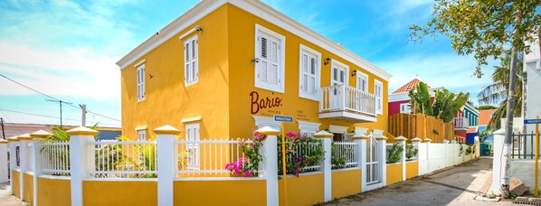 A yellow building with white shutters and a balcony, labeled "Bario Hotel & B&B." - Bario Hotel (Willemstad)