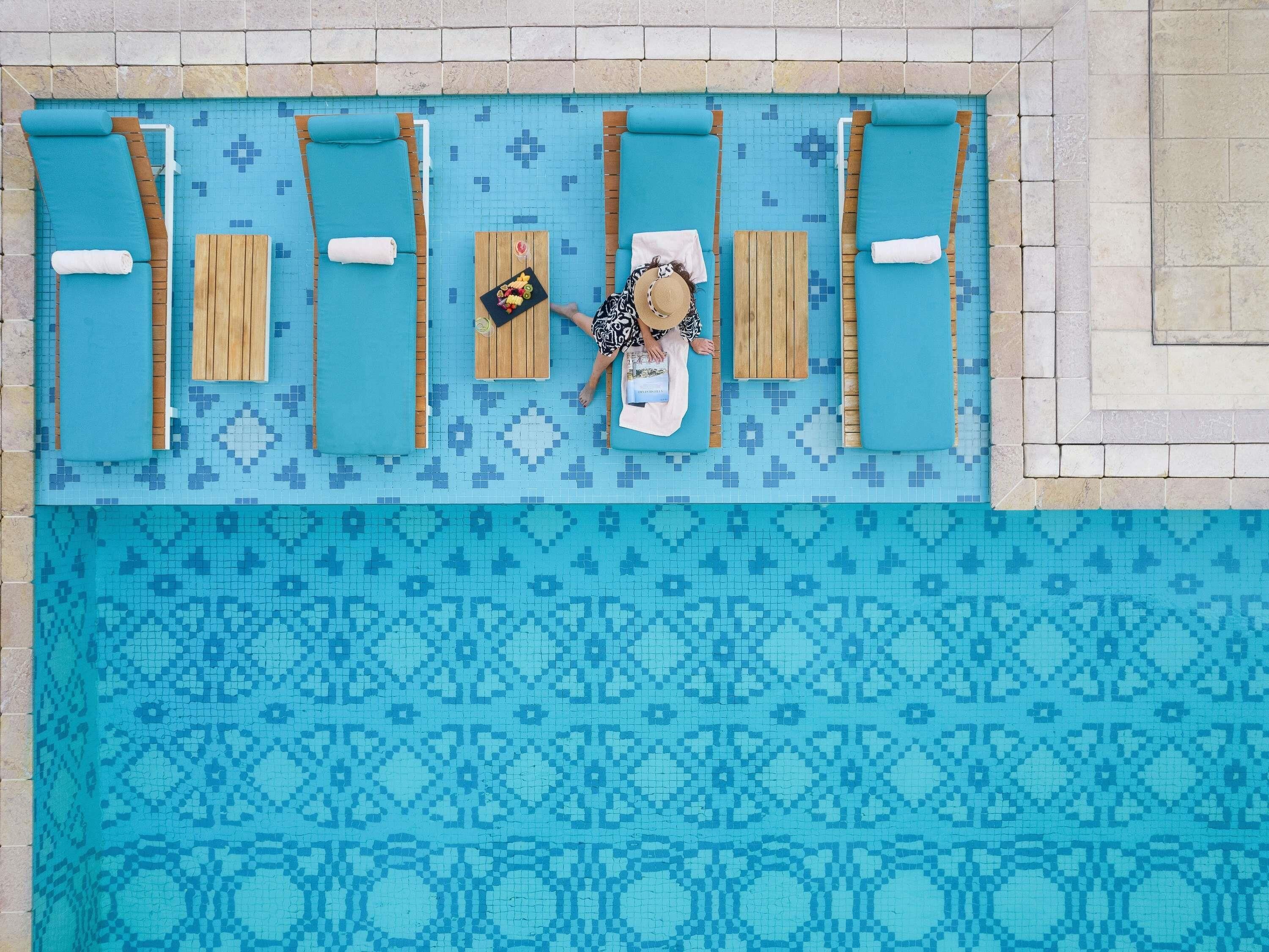 Outdoor pool, open 6:00 AM to 9:00 PM, pool umbrellas, pool loungers