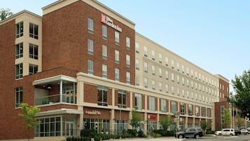 A multi-story hotel with a brick facade, large windows, and a visible restaurant named 'Marriott'.