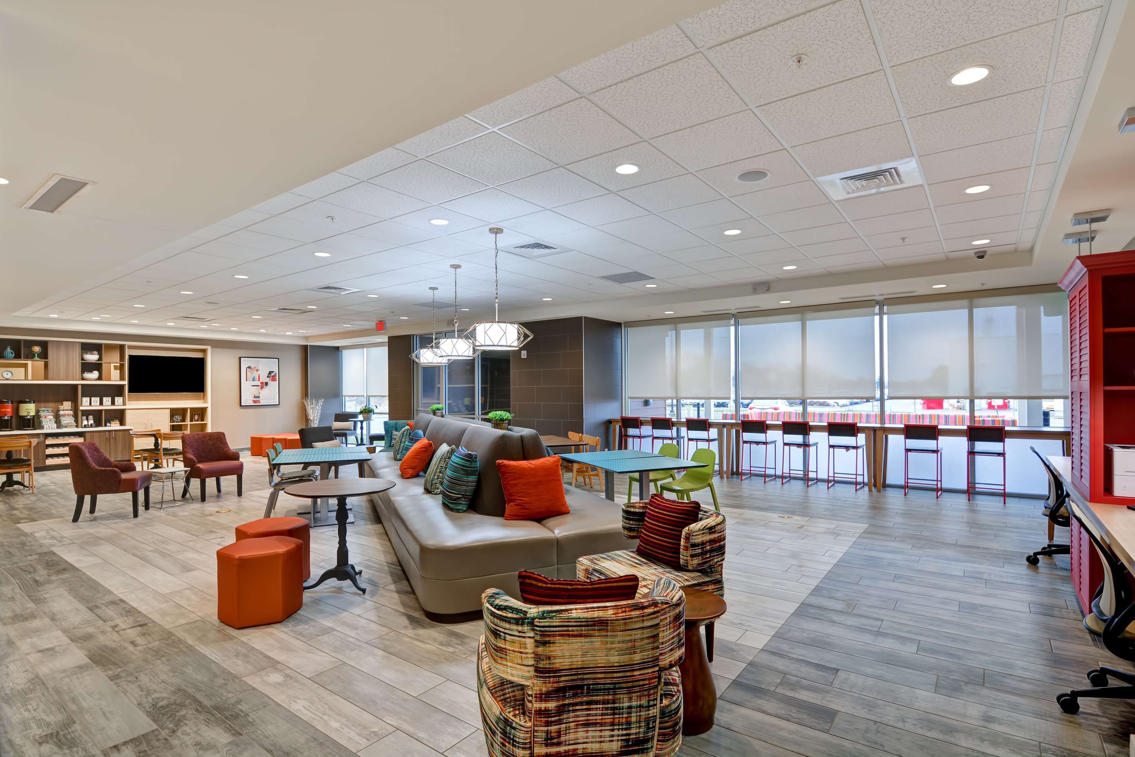 A spacious lounge area with a sofa, chairs, and a dining table.