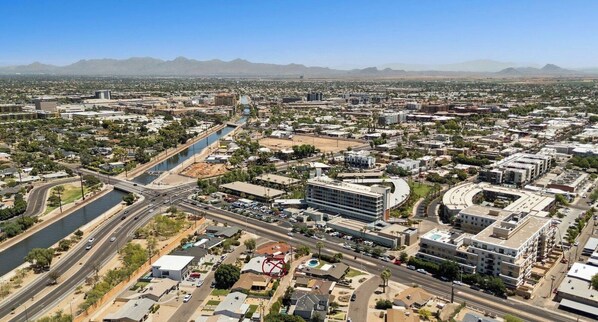An aerial view of a city with a river, roads, and buildings. - SPARKLING CLEAN-CANAL Walking/Running/Biking to Baseball, Downtown Events & Mo (Scottsdale)