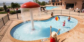 A water play area with a large water fountain, a pool, and lounge chairs. - SeaChase, 1103 East Tower, 2025 bookings now open! (Orange Beach)
