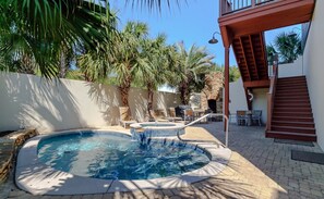 Heated pool has smaller kiddie pool and waterfall