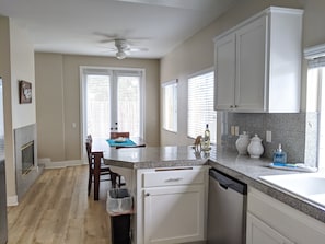 Enjoy cooking in this well-equipped kitchen with a central island, sink, and dishwasher.