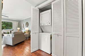 A modern living room with a grey sofa, a coffee table, and a lamp. - Beautiful Renovated Pinehurst Condo I 2 Bedroom/ 2 Bath I POOL I sleeps 4 (Pinehurst)