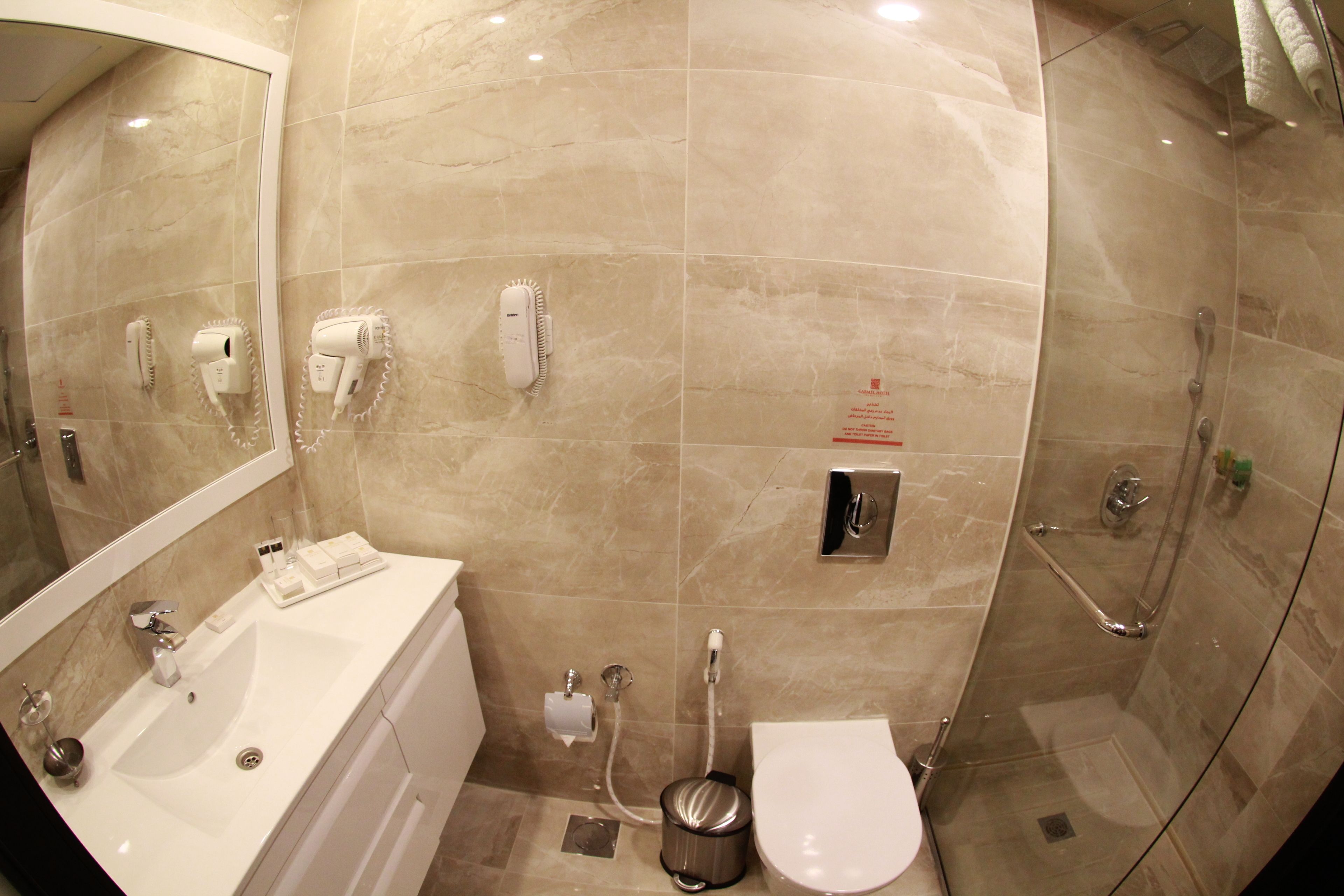 A bathroom with a sink, toilet, and shower.