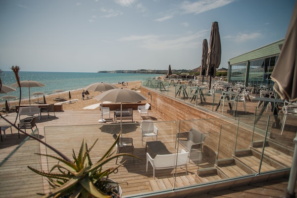 Beach nearby, white sand, sun loungers, beach umbrellas