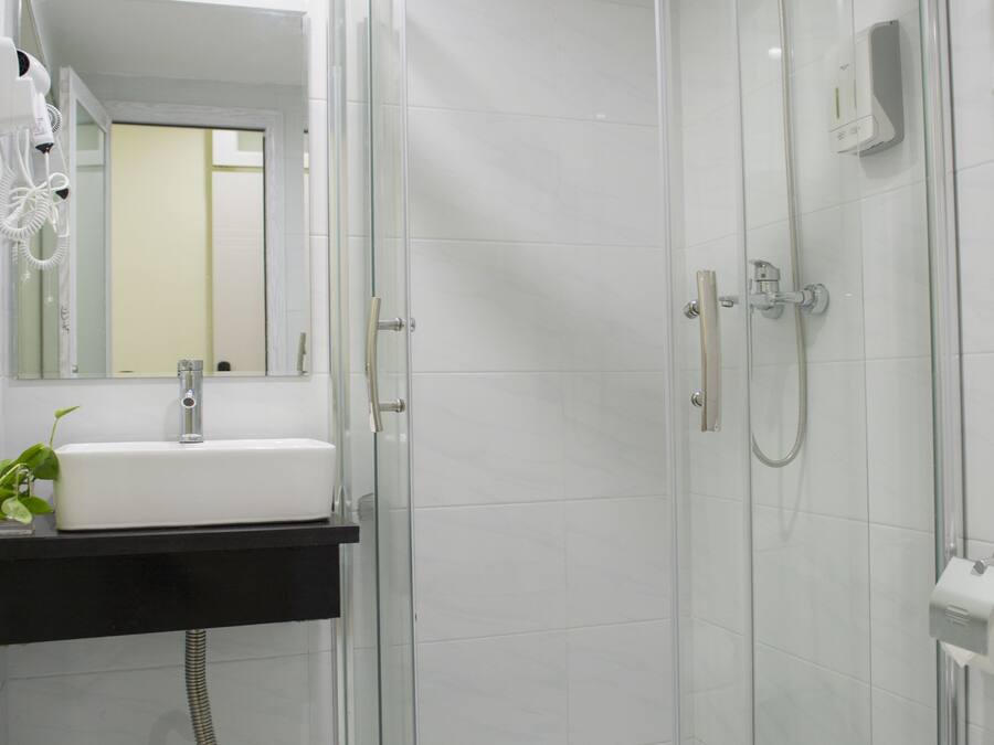 Shower, hair dryer, slippers, towels