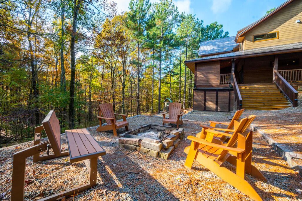 A cabin with a fire pit, outdoor seating, and a deck.