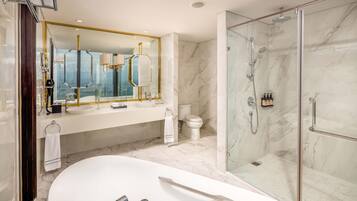Ein modernes Badezimmer mit einer großen Badewanne, einer Duschkabine und einem Marmorboden.