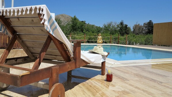 Outdoor pool, open 8:00 AM to 7:00 PM, pool umbrellas, pool loungers