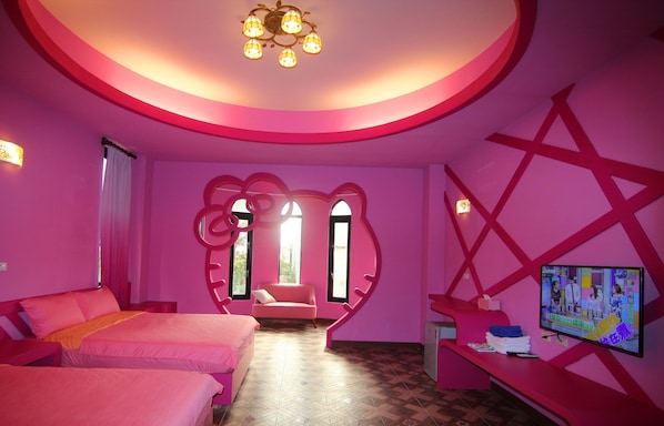 A pink-themed hotel room with two beds, a TV, and a unique heart-shaped window design.