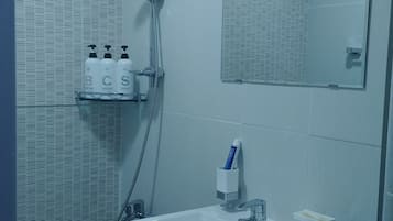 Shower, hair dryer, slippers, towels