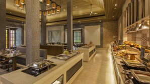 A buffet area with multiple serving stations, seating arrangements, and a variety of food options.