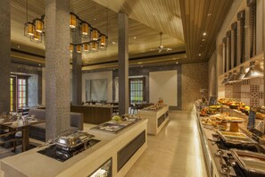 A buffet area with multiple serving stations, seating arrangements, and a variety of food options.