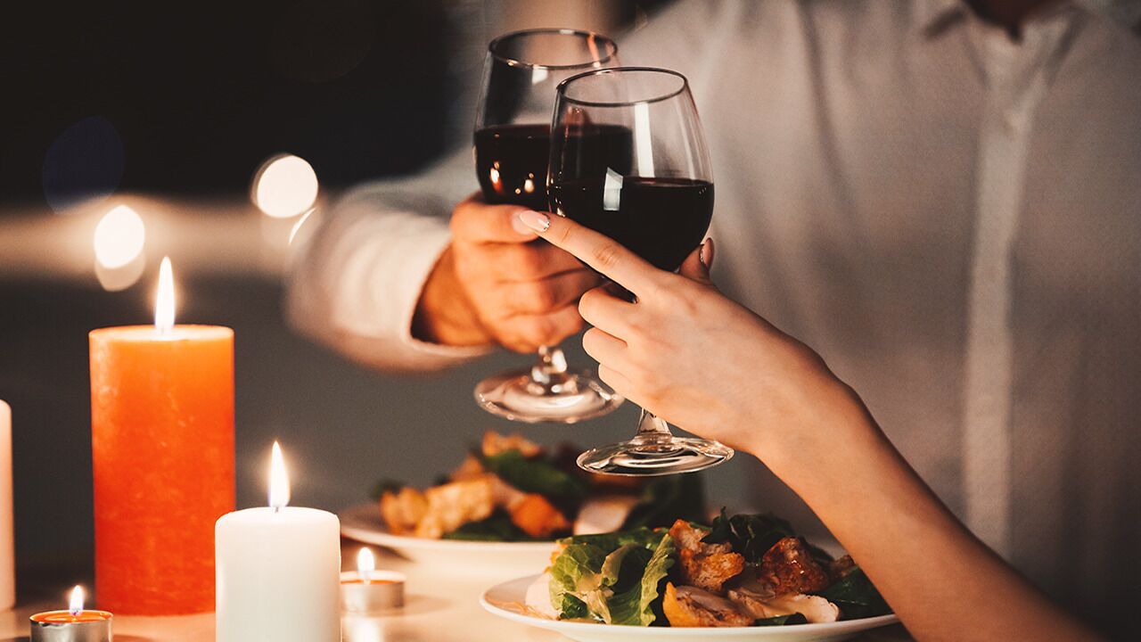 A person holding two wine glasses.