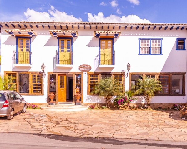 Um edifício com uma placa que diz 'POUZO TRADENTES'.