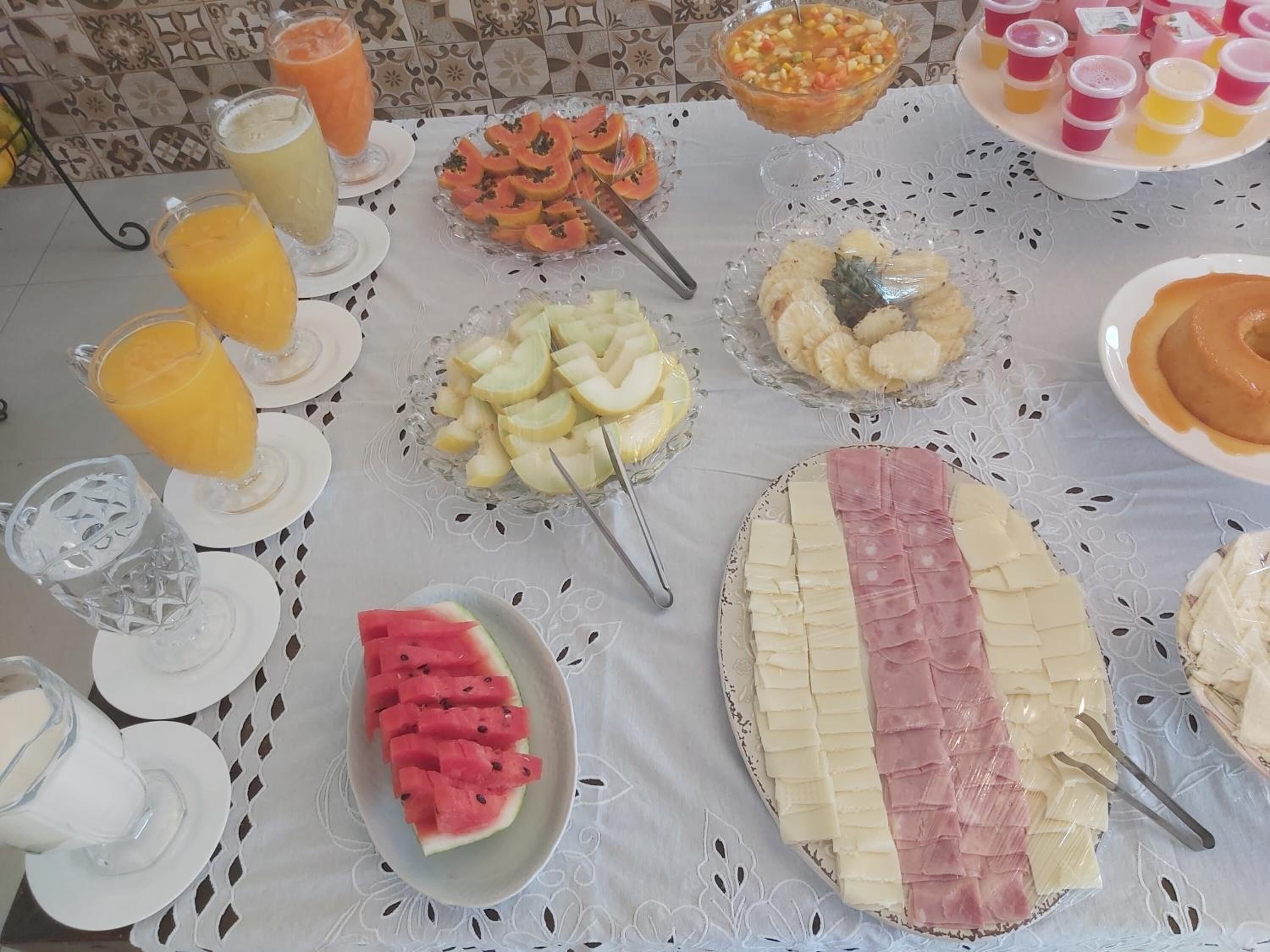 A buffet table with various food items and drinks.