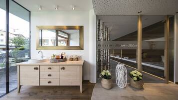 Enjoy a serene bathroom retreat with a large mirror, vanity, and sink, plus a window offering a view of the outside.