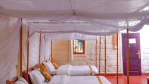 A room with two beds, each with white linens and a leopard print pillow. The room has a thatched roof and a red door. - Mara Chui Resort (Maasai Mara)