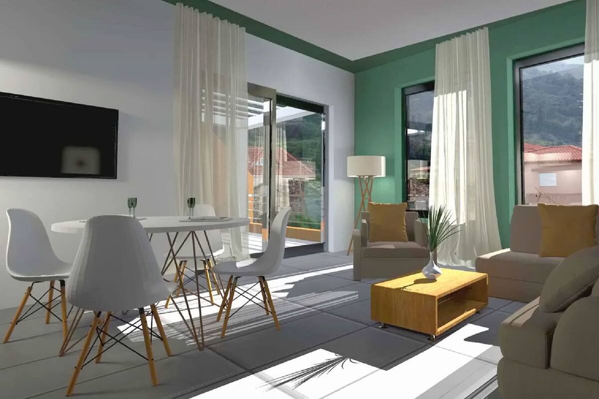 A modern living room with a dining area, large windows, and a view of the outdoors.