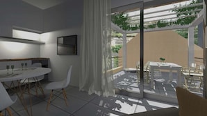 A modern interior with a dining area, a sofa, and a sliding glass door leading to an outdoor space with a table and chairs. - Derveni Luxury Apartments  (Xylokastro-Evrostina)