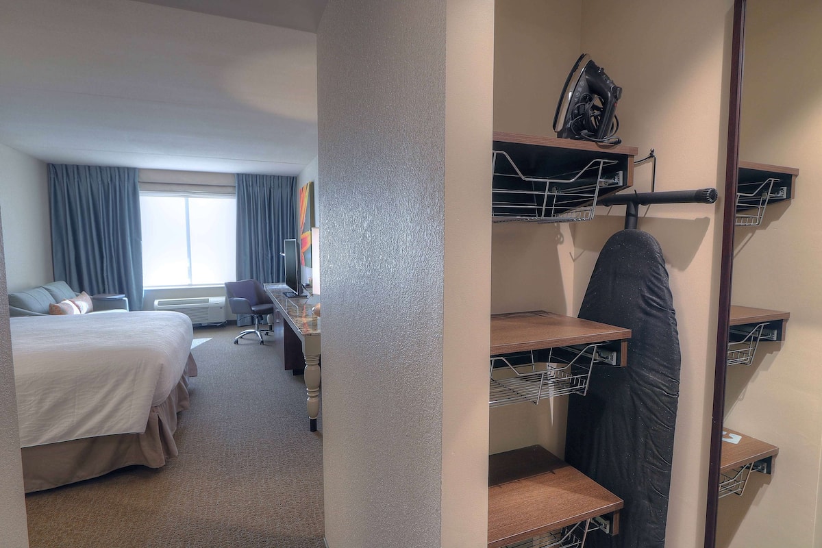 Desk, laptop workspace, blackout drapes, iron/ironing board