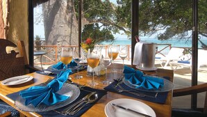 A table set for two with a view of the ocean.