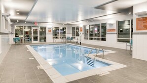 An indoor swimming pool with clear water, surrounded by a tiled floor and glass walls. - TownePlace Suites by Marriott Kansas City Liberty (Liberty)