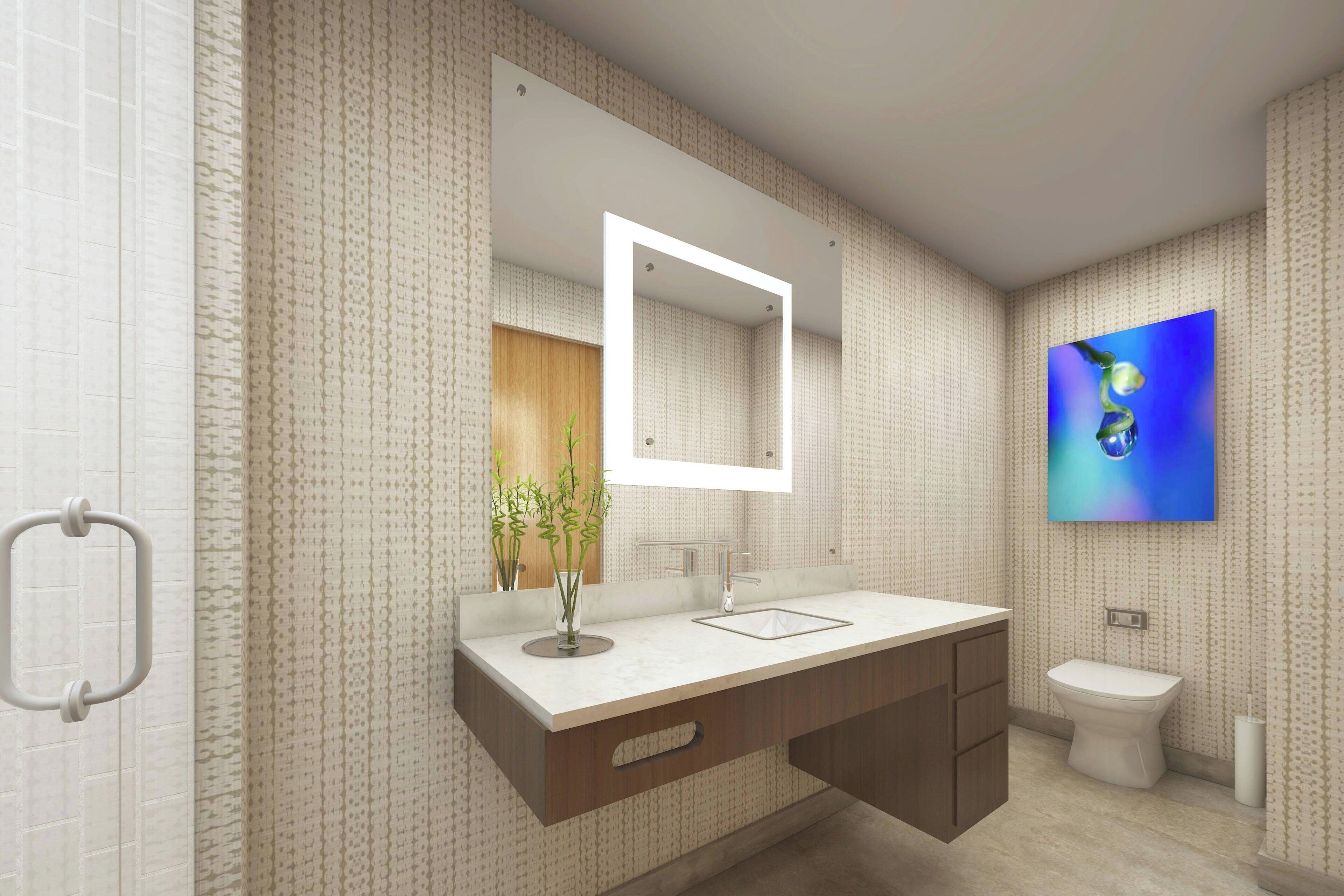 Une salle de bain moderne avec un grand miroir, un lavabo, des toilettes et un téléviseur fixé au mur.