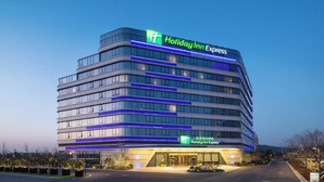 A Holiday Inn Express hotel with a modern design, featuring multiple floors and a prominent signage.