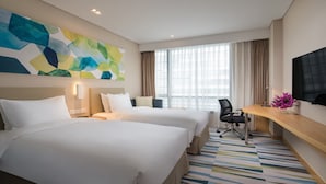 A hotel room with two beds, a desk, a chair, a TV, and a large abstract painting on the wall. - Holiday Inn Express Suzhou Taihu Lake by IHG (Suzhou)
