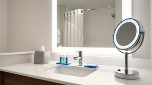A bathroom with a white sink, a mirror, and a towel rack. - Holiday Inn Express & Suites West Des Moines - Jordan Creek by IHG (West Des Moines)