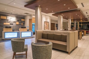 A modern lobby with a reception desk, seating area, and a coffee station. - Holiday Inn Express & Suites Farmville by IHG (Farmville)