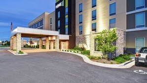 A modern hotel with a prominent "HOME 2" sign, a covered entrance, and a parking area with a handicap parking space. - Home2 Suites by Hilton Springfield North (Springfield)