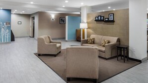 A spacious lobby with a beige sofa, two armchairs, a small table, and a lamp. - Sleep Inn Big Spring North I-20 (Big Spring)