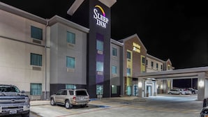 A Sleep Inn hotel with a modern design, featuring a prominent sign, a parking lot with several cars, and a MainStreet Subs restaurant. - Sleep Inn Big Spring North I-20 (Big Spring)