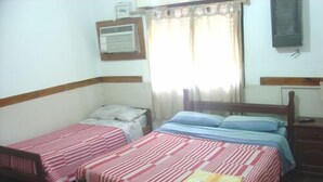 A room with two single beds, a window with curtains, an air conditioning unit, and a small bedside table. - Prisma Apart Hotel (La Rioja)