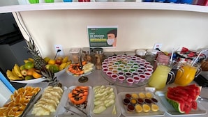 A buffet with various fruits, vegetables, and beverages. - Hotel Rochamar (Penha)
