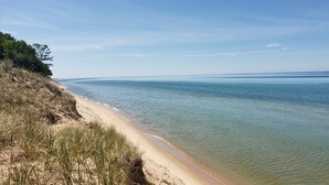 A beach with clear water and a sandy shore. -  LAKE MICHIGAN BEACHFRONT! PRIVATE BEACHFRONT! DISCOUNTED SEASONAL RATES  (Montague)
