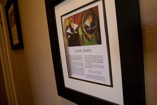 A framed picture of a character with the title 'Snow White' and a portion of the text below it.