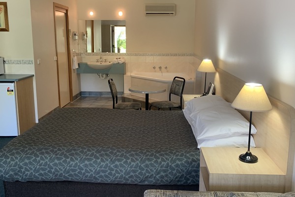 Premium bedding, desk, laptop workspace, iron/ironing board
