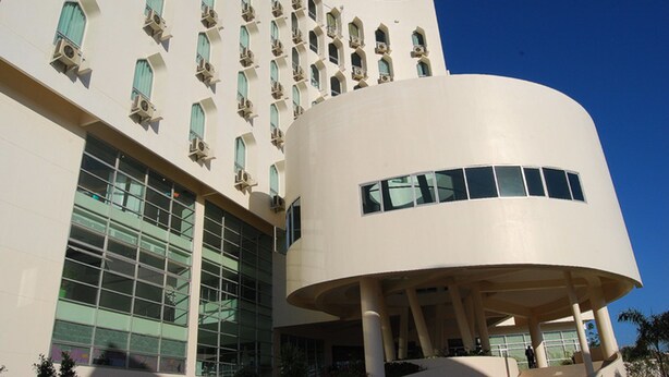 A modern building with a curved structure and multiple windows. - Grand Southern Hotel (Thung Song)