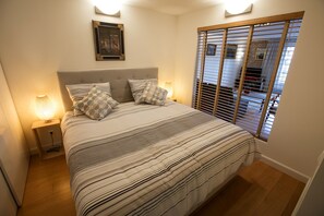 1 bedroom, desk, iron/ironing board, travel crib