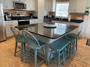 Enjoy cooking in this well-equipped kitchen with a central island and stainless steel appliances.