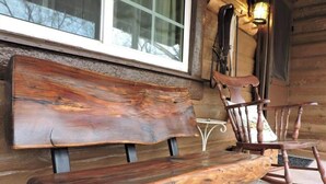 A rustic wooden bench and chair in a cabin setting. - Cabin (Prescott)