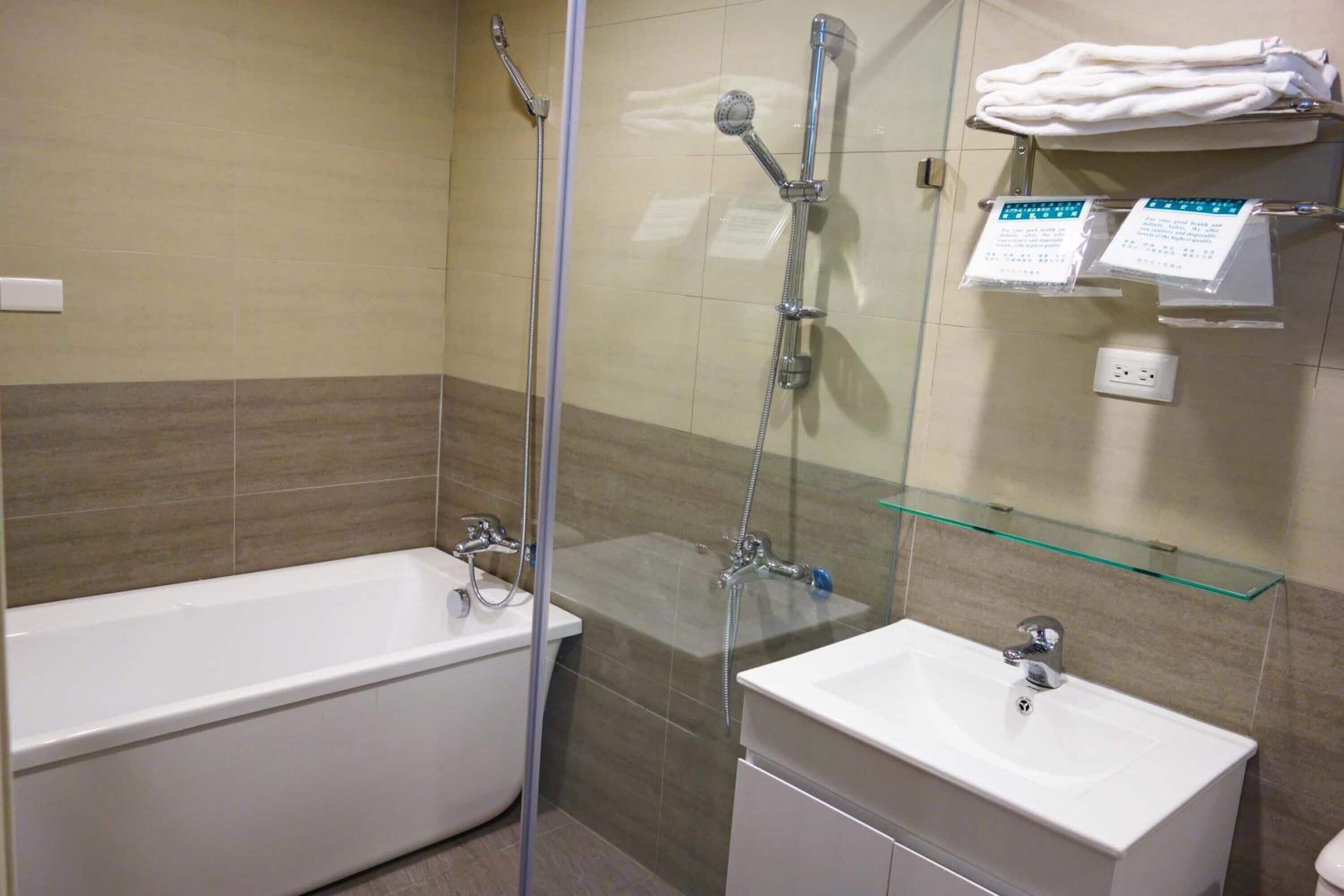 shower, hair dryer, slippers, towels