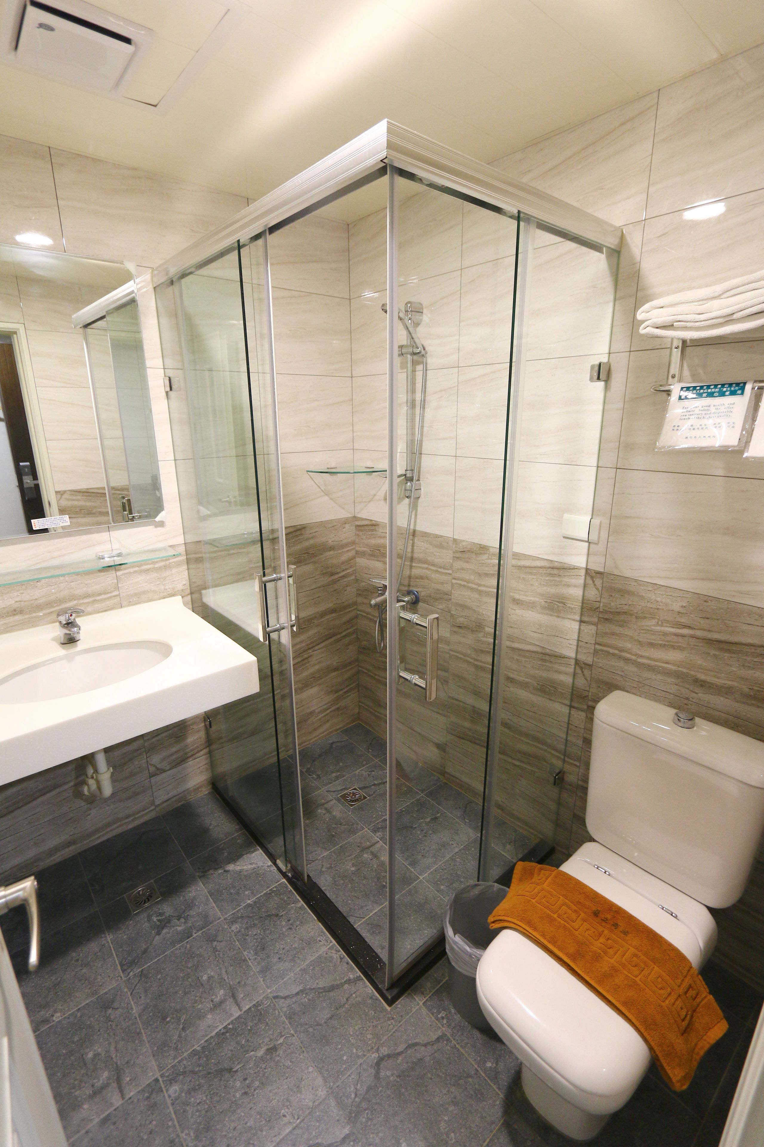 shower, hair dryer, slippers, towels