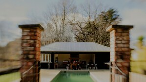 A swimming pool with a covered patio area, surrounded by brick pillars. - Wallingford Homestead (Wallingford)