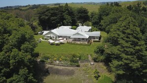 A large, white, two-story building with a spacious lawn and outdoor seating area. - Wallingford Homestead (Wallingford)